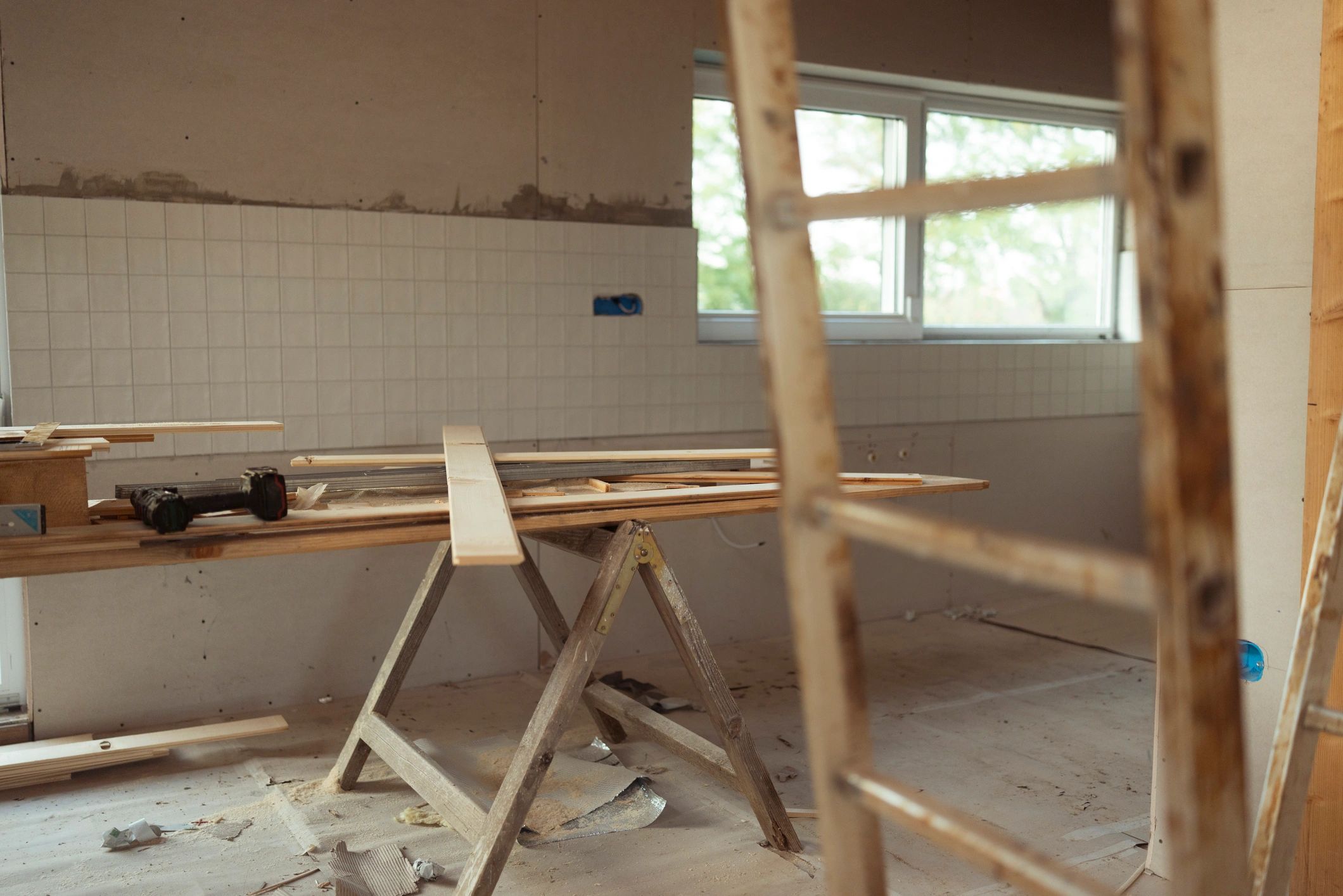 Interior under construction showing timber framing and tools